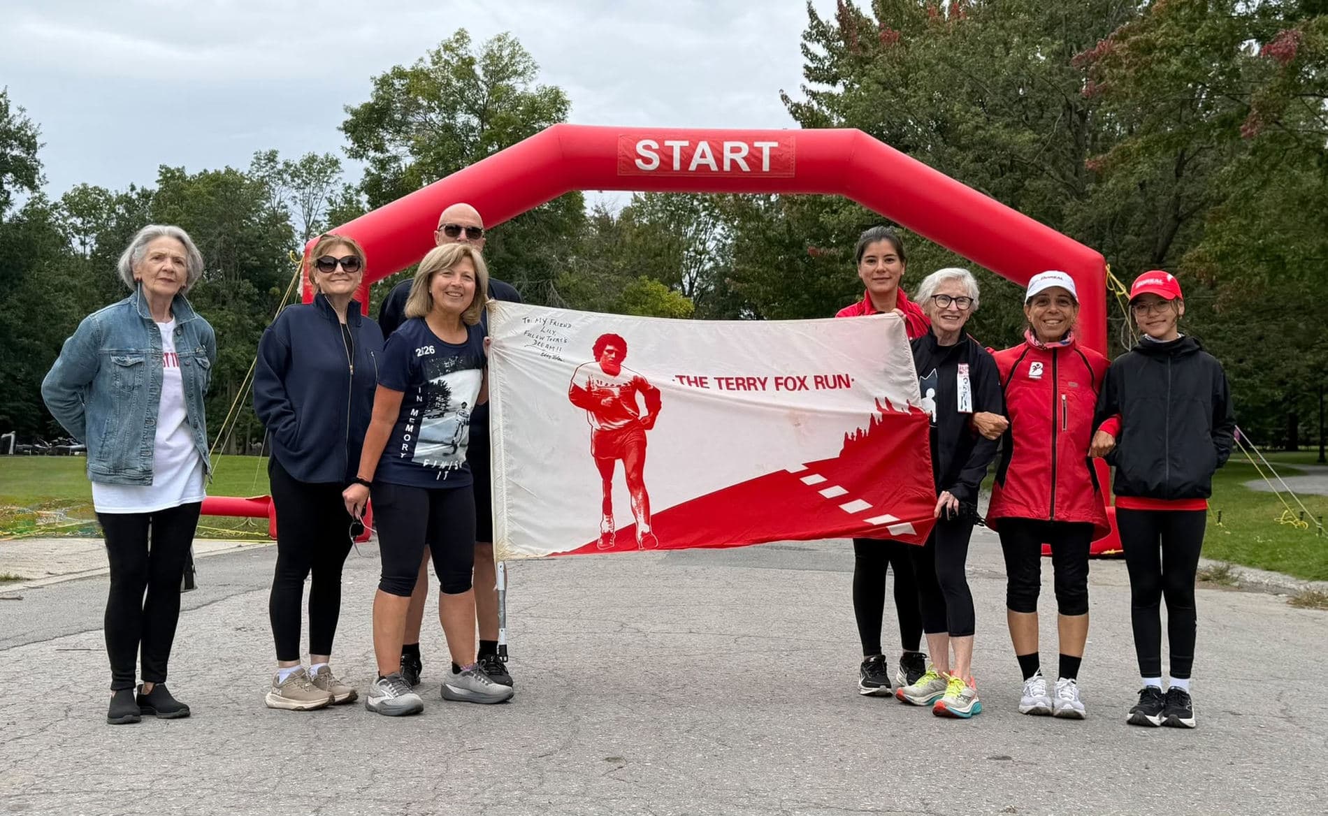 Des membres du club Boréal autour d’une bannière de la course Terry Fox.
